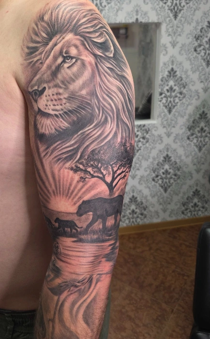 loewe-afrika-realism-tattoo-oberarm-pirna-saints